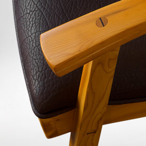 Close-up view of the handmade upholstery and handcarved accents on the Tashjian Chair
