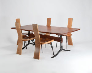 Our custom hand-carved Salin Dining Table set with The Salin Side Chair