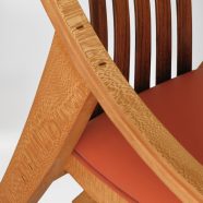 Close-up view of the hand carved custom curve armrest on the Elrod Chair