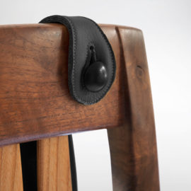 Close-up view of where the custom upholstery connects to the hand-carved McCorkle Chair
